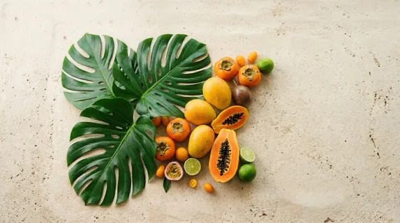 a graphic composition of stunning monstera leaves elegantly arranged on a sandy textured countertop, emphasizing the clear subject separation with ample generous negative