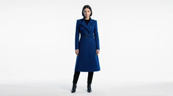 Sleek model showcasing structured sapphire-blue coat against minimalist white backdrop, sharp tailored lines emphasizing silhouette, cool tones dominating composition,