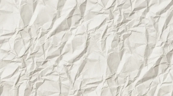 A seamless white crumpled paper surface with tileable wrinkles, crisp folds and clean high-resolution craft texture, ultra-realistic, no logos.