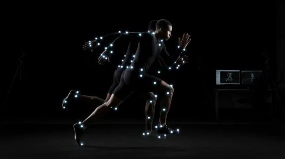 A biomechanics laboratory capturing a sprinter mid-stride in a motion capture suit, reflective marker spheres covering every joint glowing white against a matte black