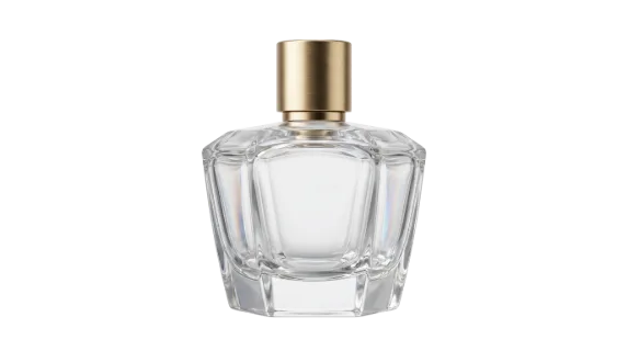 A luxurious, clear glass perfume bottle with geometric facets and a metallic gold atomizer cap is presented isolated on a clean white surface