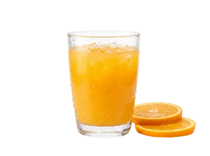 A tall, condensation-covered glass filled with vibrant orange juice and ice cubes sits next to two fresh orange slices, evoking a sense of cool refreshment