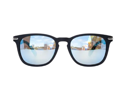 A pair of modern sunglasses with a matte black frame and reflective blue lenses showing a sky and building reflection