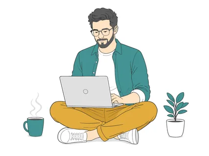 A man with glasses and a beard works on his laptop while sitting comfortably on the floor, with a steaming mug of coffee and a potted plant nearby