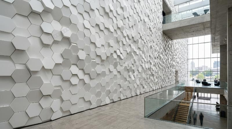 Panoramic wall of randomly shifted white honeycomb hexagons, clean geometric relief, modern architectural atmosphere, ultra-realistic, no logos.