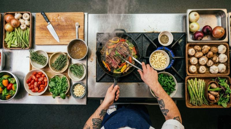 Top view of a chef cooking with fresh ingredients in a kitchen, restaurant menu concept, rich food textures and culinary action, ultra-realistic, no logos.