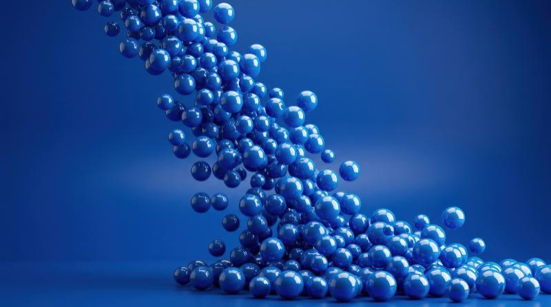 A cascade of blue balls against a monochrome blue background, glossy motion, rhythmic visual balance, ultra-realistic, no logos.