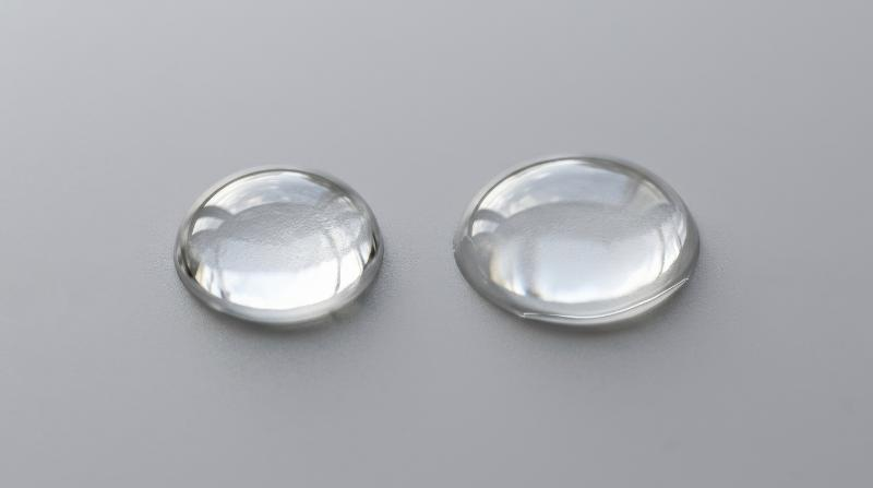 Two transparent micellar water drops isolated on a neutral grey background, crisp cleansing purity and glossy hydration texture, refined dermatology mood, ultra-realistic, no logos.