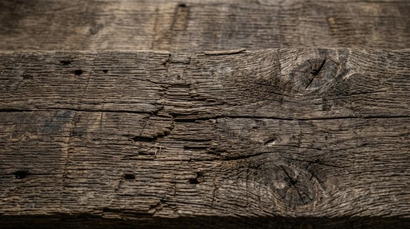 Old wood texture with aged grain and worn patina, rustic tactile detail, timeless natural atmosphere, ultra-realistic, no logos.