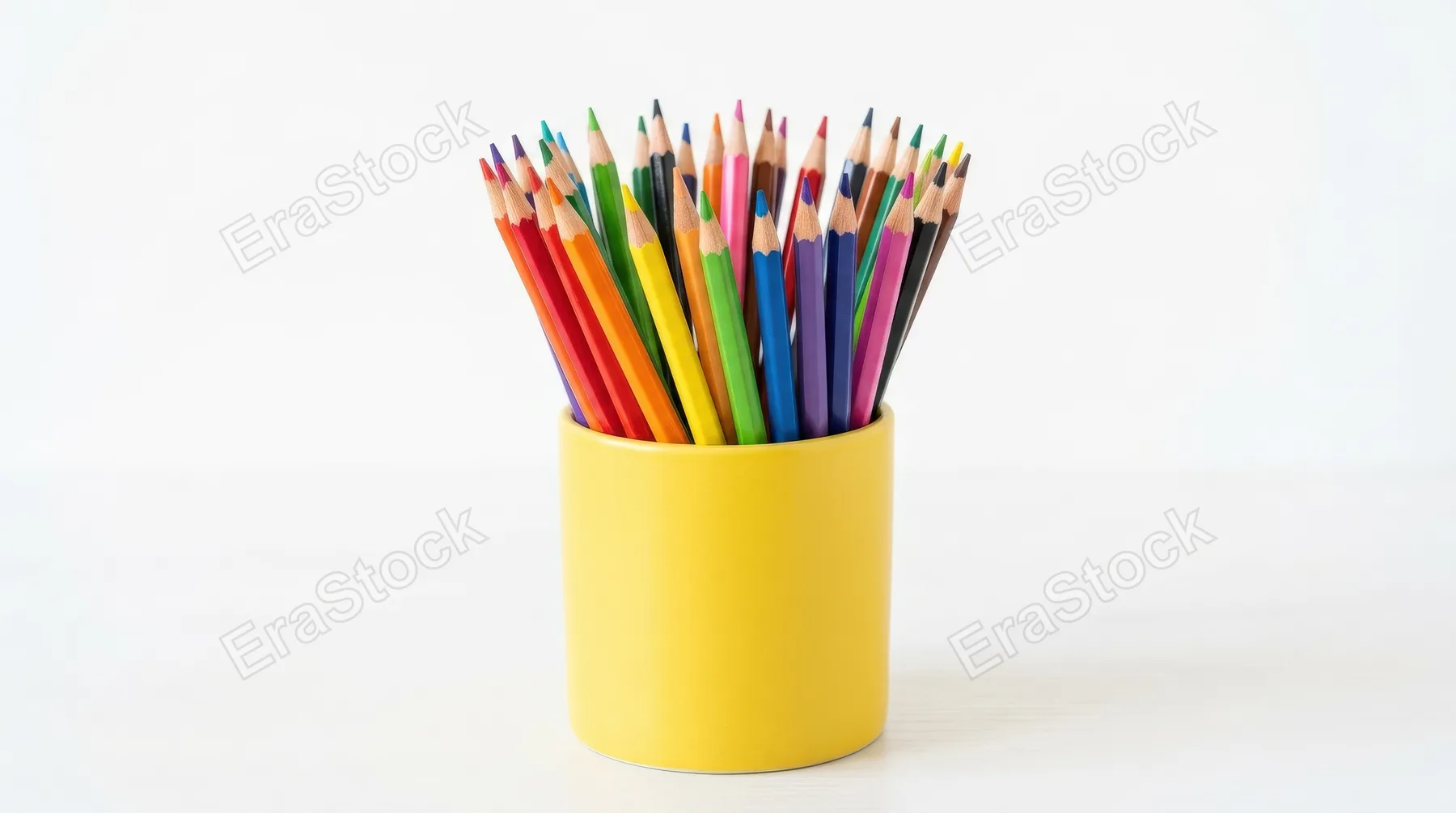 A set of colored pencils standing upright in a bright yellow holder against a clean white background, sharp tips and vivid hues, cheerful creative atmosphere, ultra-realistic, no logos.