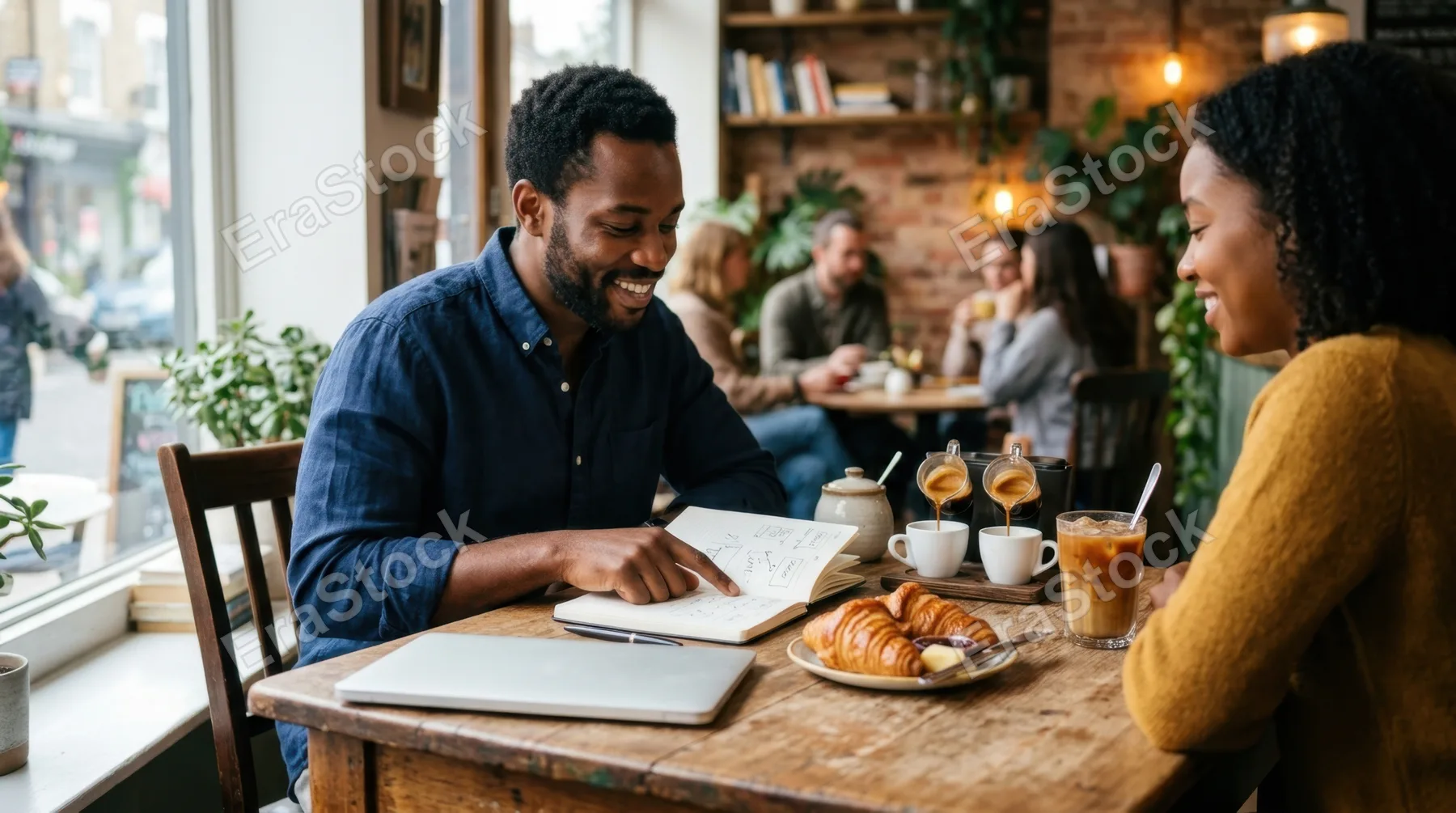 in a cozy cafe, a 30-year-old black male product developer engages in quiet collaboration over coffee, seated at a wooden table. the scene features espresso shots being