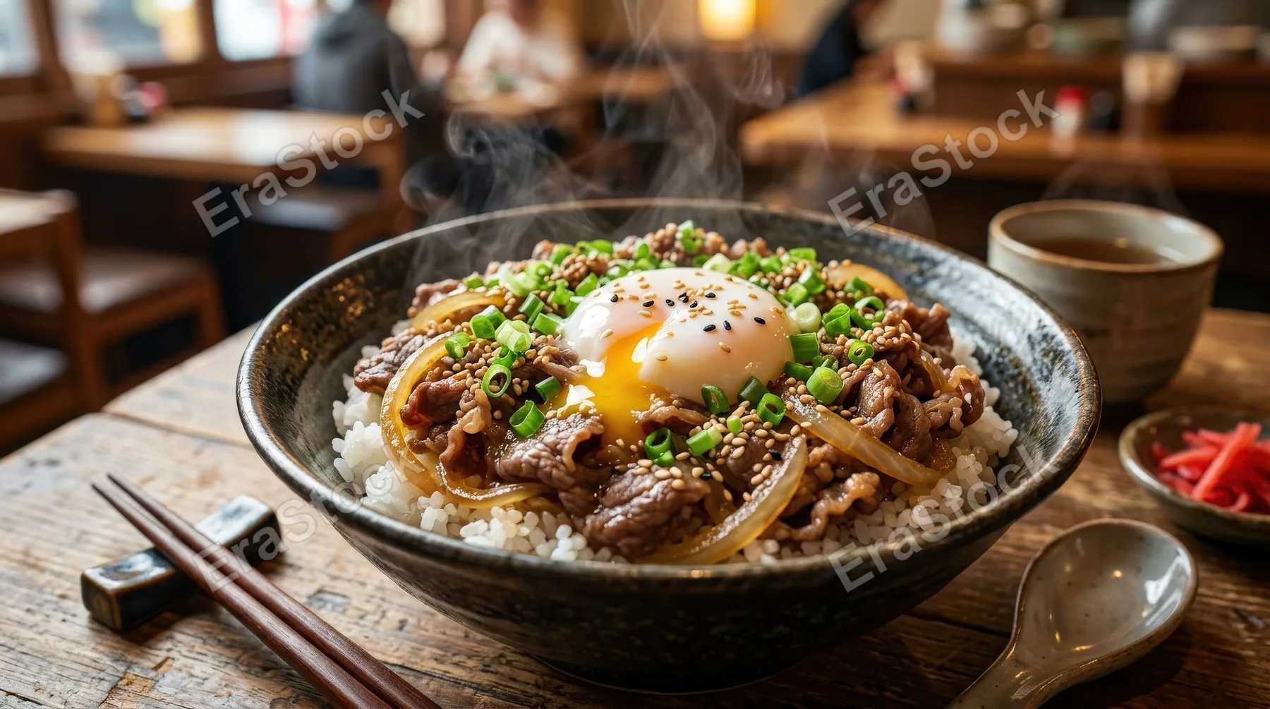 A steaming bowl of rice with thinly sliced beef, onions, and a poached egg, topped with sesame seeds and green onions, comforting restaurant-style presentation, ultra-realistic, no logos.