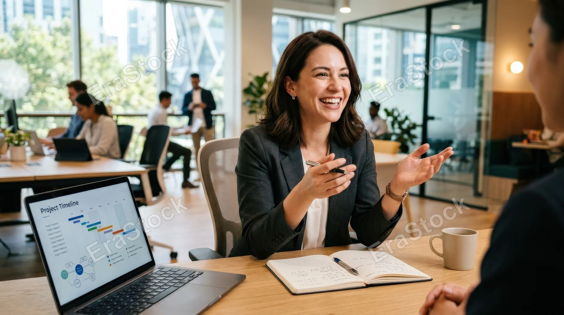 A smiling professional woman discussing a project in a modern office, engaged expression, clean workspace, soft daylight and a capable optimistic atmosphere, ultra-realistic, no logos.
