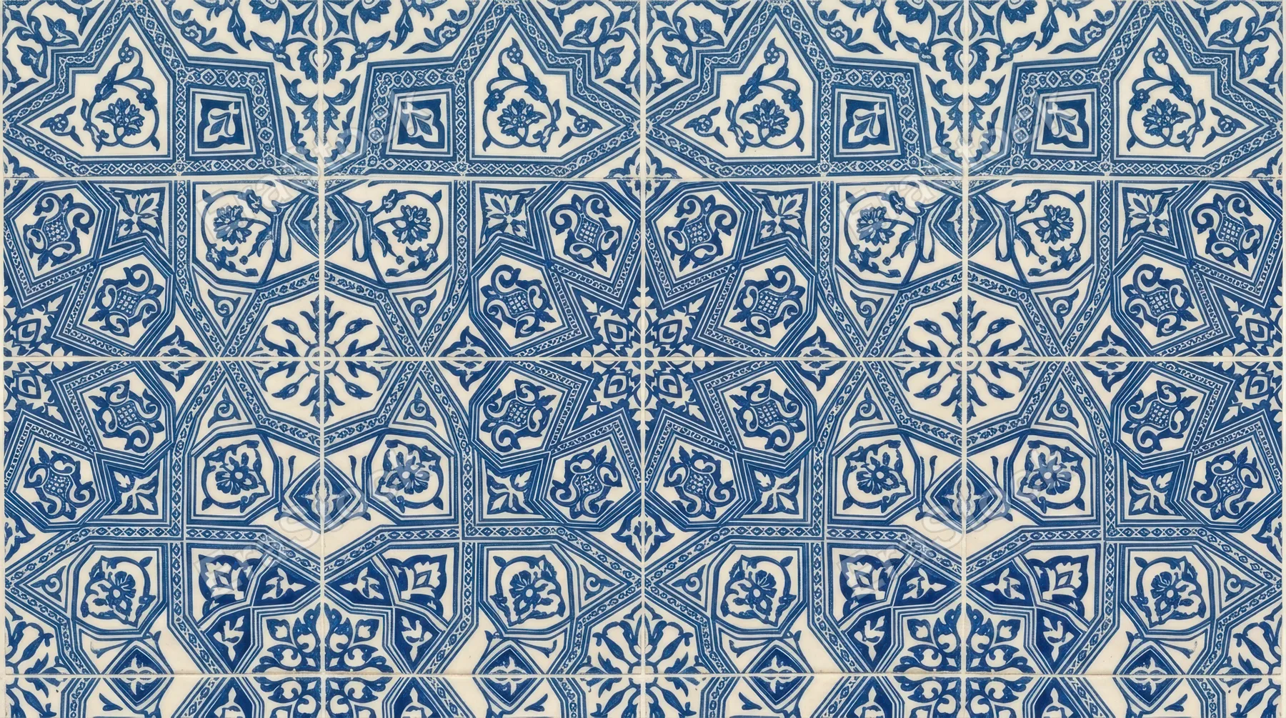 Decorative blue patterned surface with geometric and floral motifs arranged symmetrically, clean flat perspective emphasizing design clarity, subtle texture visible under