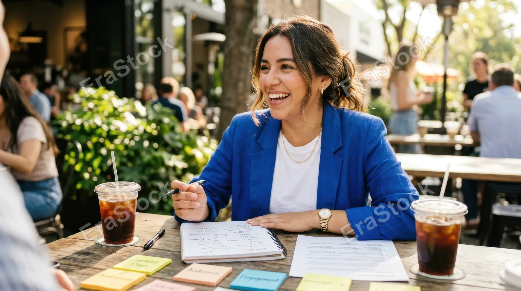 a 25-year-old hispanic female intern engaged in a brainstorming session is captured in a close-up scene, surrounded by printed notes and two iced americanos on a sunny