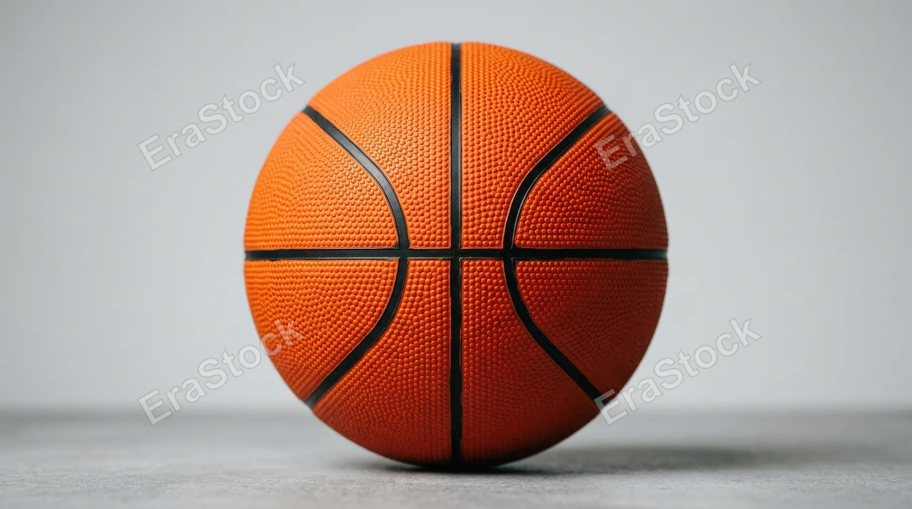 An orange basketball isolated on a clean backdrop, pebbled surface texture and bold sporty color, active recreation mood, ultra-realistic, no logos.