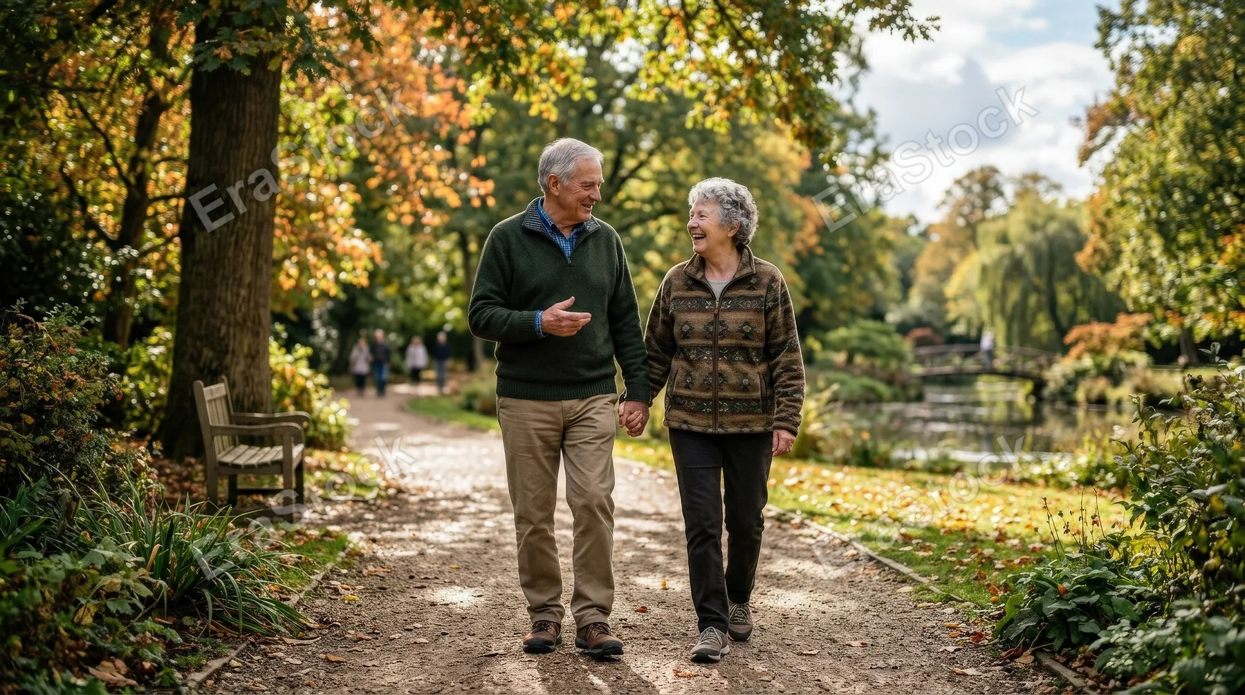 An elderly couple walking and chatting in the park, relaxed smiles, gentle natural light and peaceful everyday companionship, ultra-realistic, no logos.