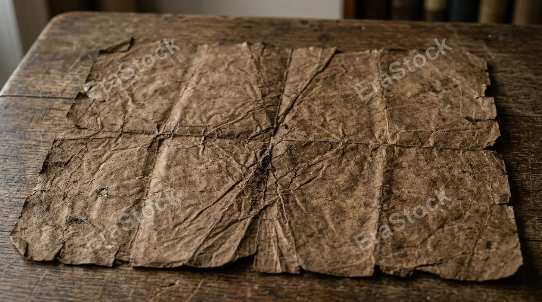 Vintage brown crumpled paper with folded creases, parchment texture, warm earthy tones and subtle age marks, rustic archival atmosphere, ultra-realistic, no logos.