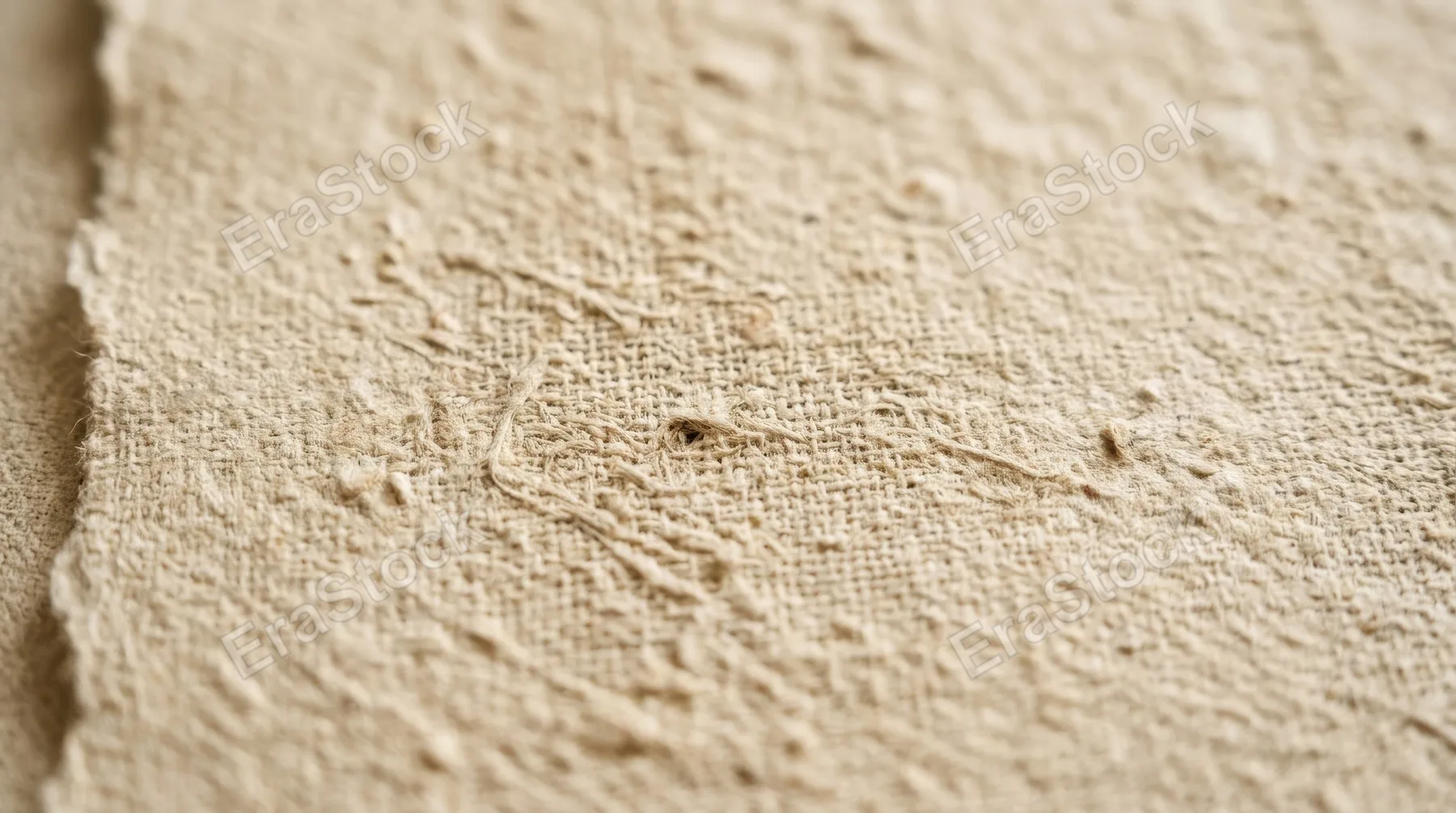 A soft beige textured surface resembling natural fabric and handmade paper, subtle grain, warm tactile calm and understated premium elegance, ultra-realistic, no logos.
