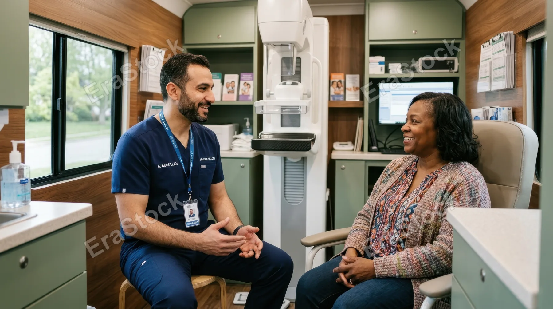 a 39-year-old middle eastern male mammography technologist is engaged in a warm conversation with a patient inside a bright and well-organized healthcare van. the