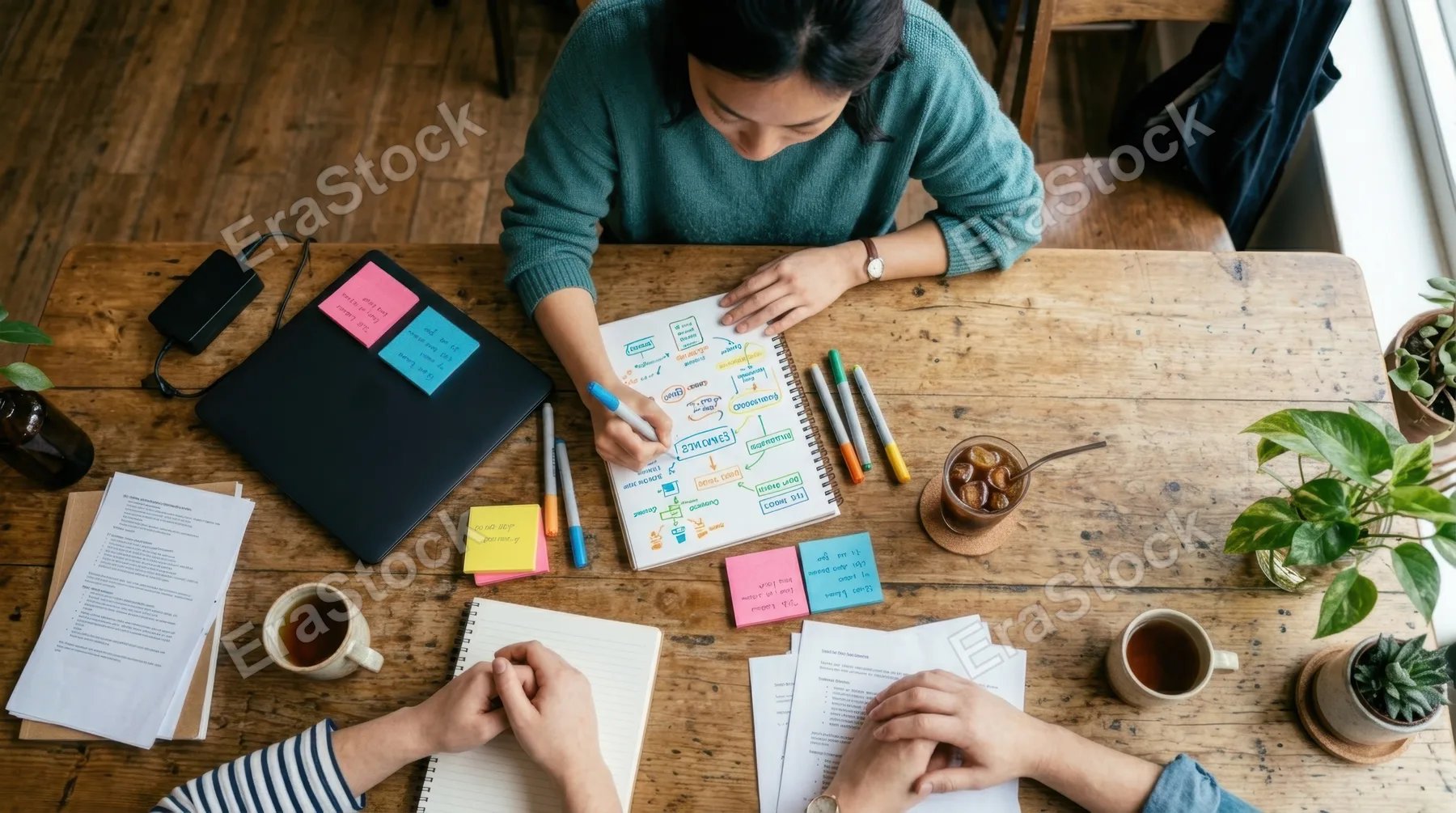 an overhead perspective captures a warm and inviting cafe scene, featuring a 30-year-old east asian female project leader engaged in a thoughtful conversation over a