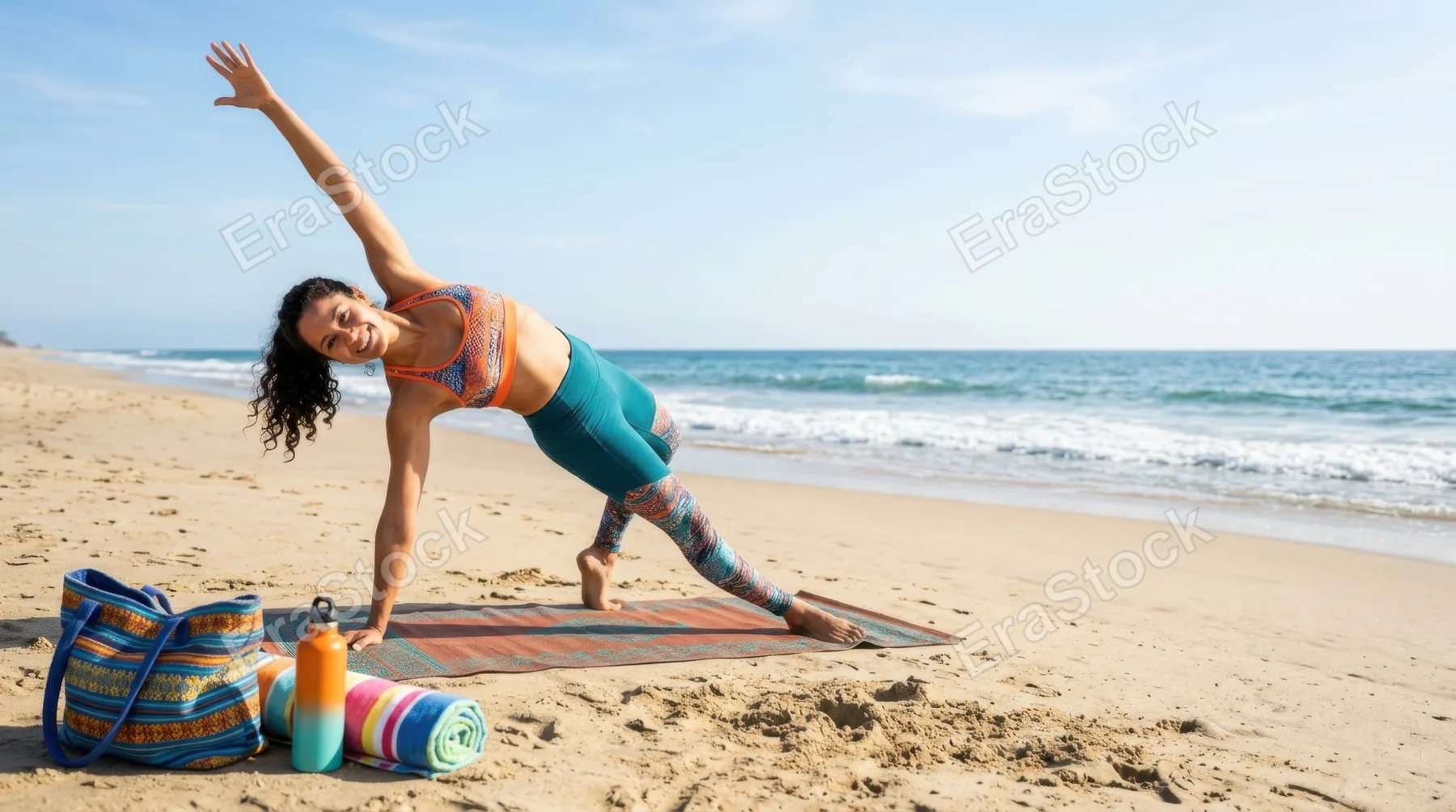 a bold, graphic composition of the 33-year-old hispanic female yoga instructor in a vibrant yoga pose against a sandy shore backdrop, with an emphasis on generous