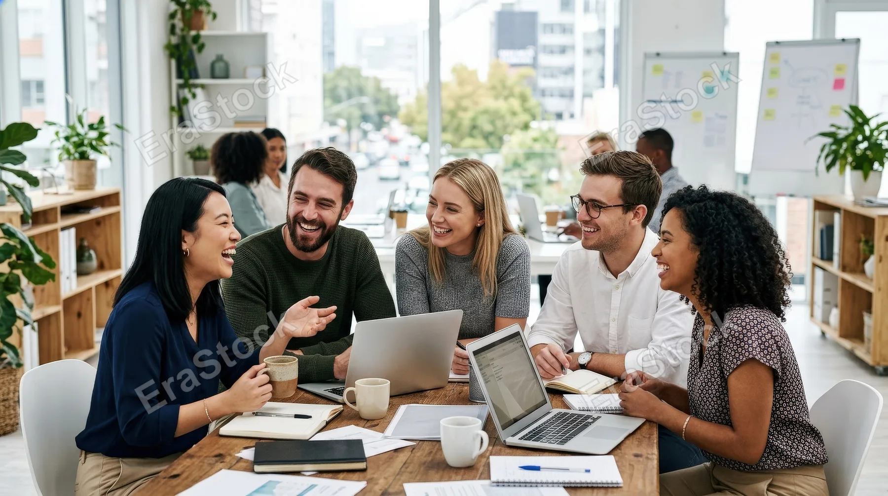 A group of young professionals smiling and enjoying each other's company in an office, candid interaction, bright workspace and a warm team-bonding atmosphere, ultra-realistic, no logos.