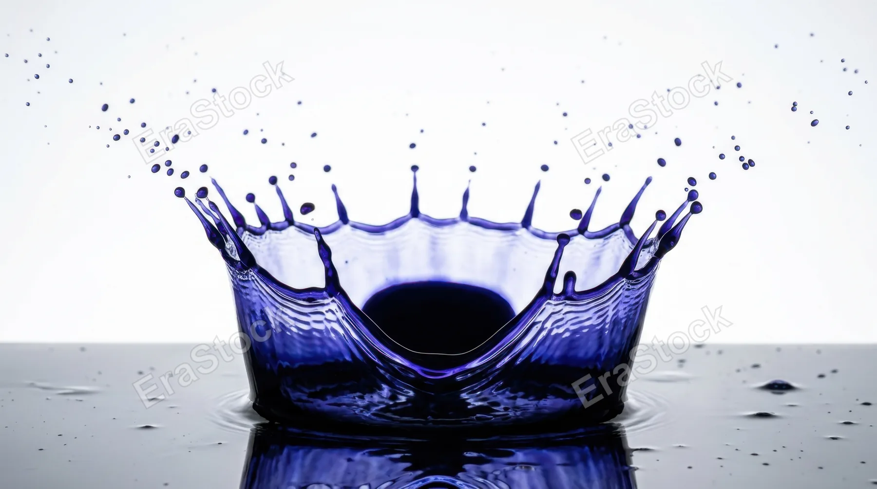 Frozen splash of deep indigo ink captured at the precise microsecond of maximum crown formation, the classic crown shape with perfect pointed spires rising symmetrically