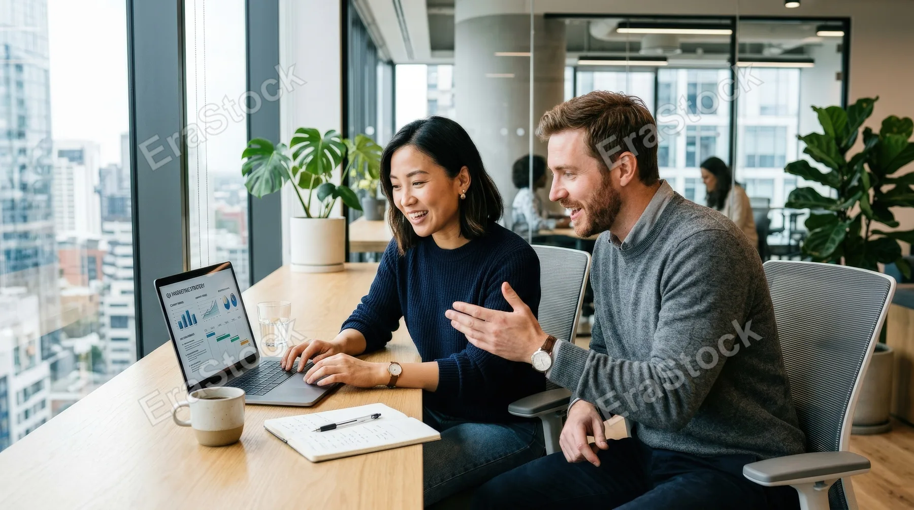 Two colleagues sharing ideas while working on a laptop in a modern office, contemporary furniture, bright windows and engaged expressions, smooth collaborative mood, ultra-realistic, no logos.
