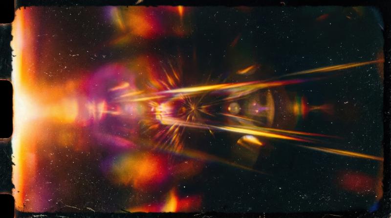 A dramatic abstract film light leak with rich flare streaks, layered glow and cinematic darkness, vintage poster atmosphere, ultra-realistic, no logos.