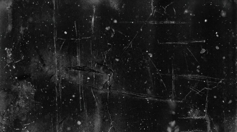 Dark film grain overlay on black with scratches and drifting dust, distressed retro texture for aged photography, moody and timeworn, ultra-realistic, no logos.
