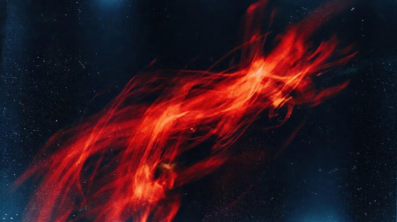 Abstract red light leak on black with motion blur, cool blue lens tint and grainy film texture forming a dramatic retro contrast, ultra-realistic, no logos.
