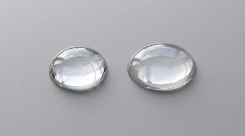 Two transparent micellar water drops isolated on a neutral grey background, crisp cleansing purity and glossy hydration texture, refined dermatology mood, ultra-realistic, no logos.