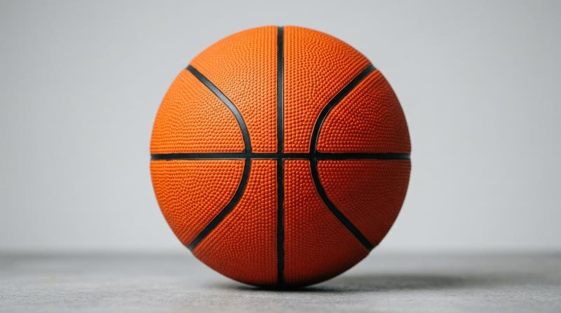 An orange basketball isolated on a clean backdrop, pebbled surface texture and bold sporty color, active recreation mood, ultra-realistic, no logos.